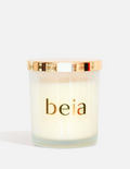 Beia candle with a gold lid on a white background