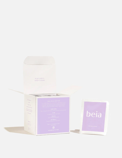 A skincare product set featuring a white box with a lavender interior label and a matching single-use packet labeled 'beia' in white text on a lavender background, set against a clean white background.
