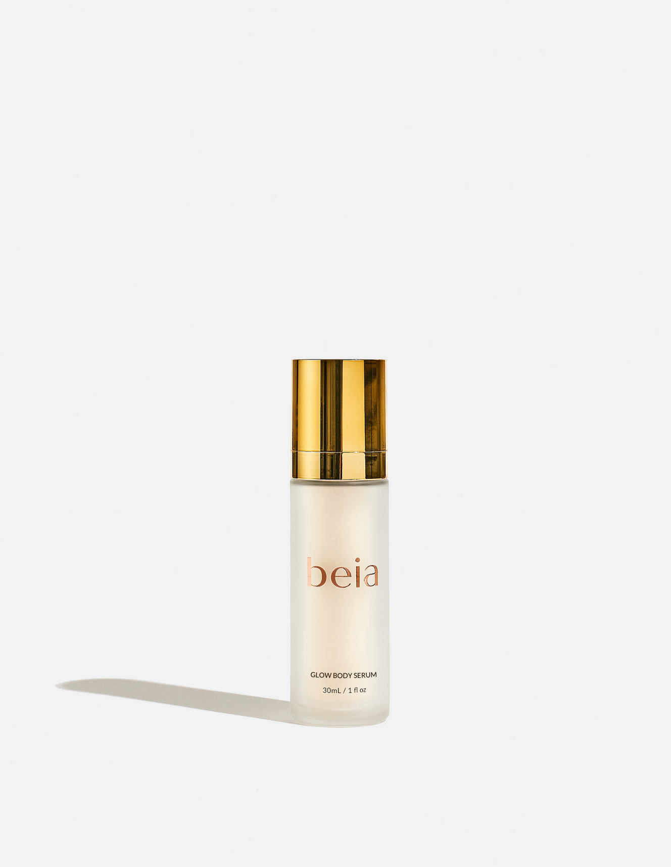 Skincare serum bottle with gold cap on a white background