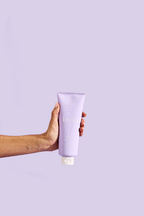 Purple tube of beia body scrub on a purple background