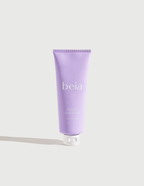 Purple tube of beia body scrub on a light gray background