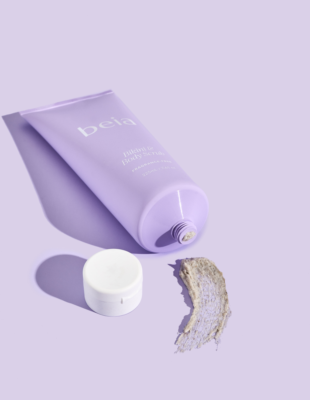 Purple tube of beia body scrub on a purple background