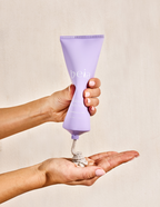Purple tube of beia body scrub on a light gray background