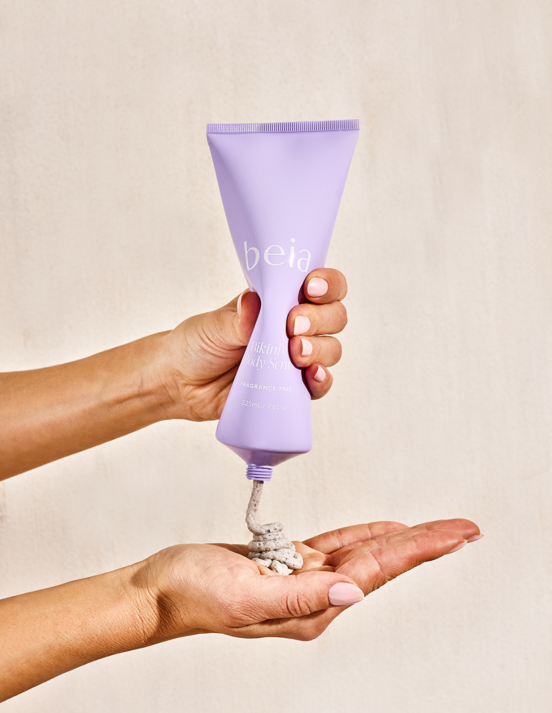 Purple tube of beia body scrub on a light gray background
