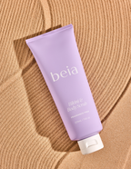 Purple tube of beia body scrub on a sand colored background