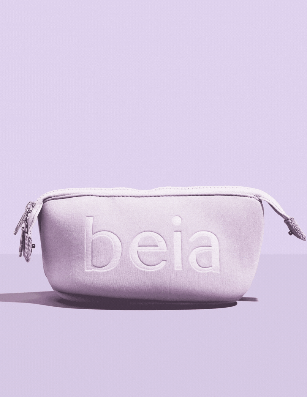 purple background with a purple beia toiletry travel bag 2